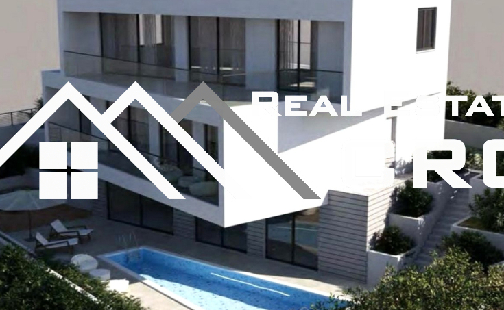 Modern villa with a pool and garage, situated in a peaceful setting with a beautiful sea view, for sale